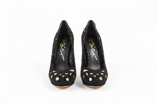 Black high-heeled shoes with gold heart designs on a white surface