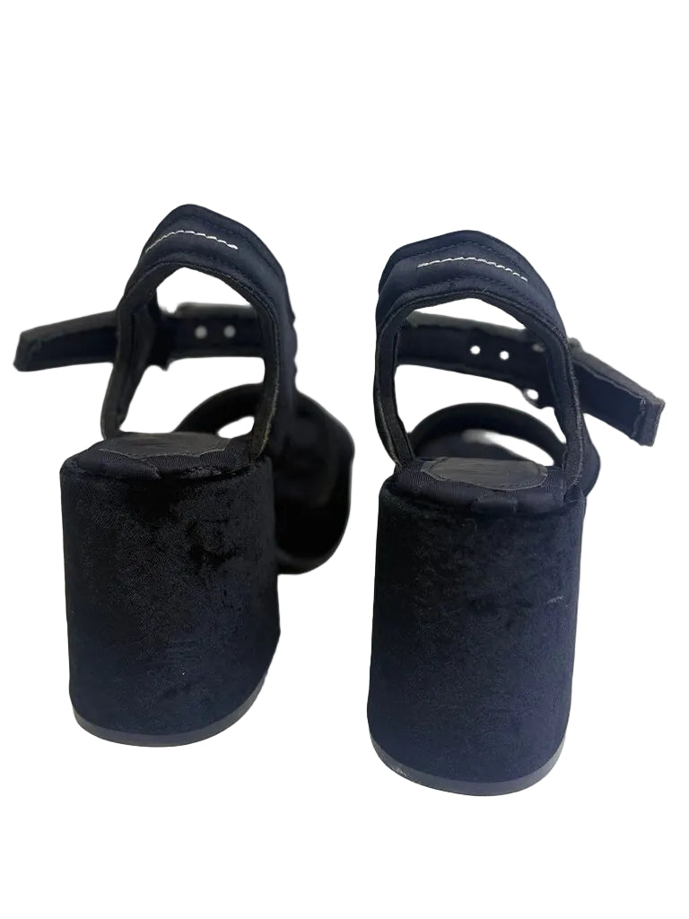 Pair of black high-heeled shoes on a white background