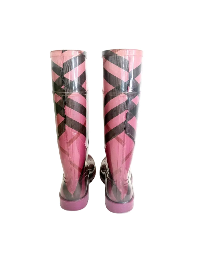 Pink and black checkered rain boots on a white background