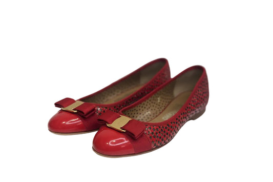 Red shoes with gold accents on a white background