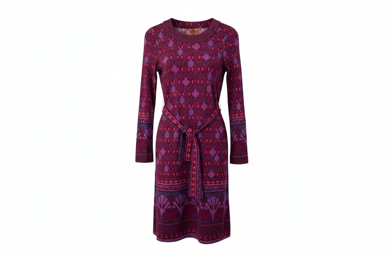 Purple patterned dress on a hanger against a white background