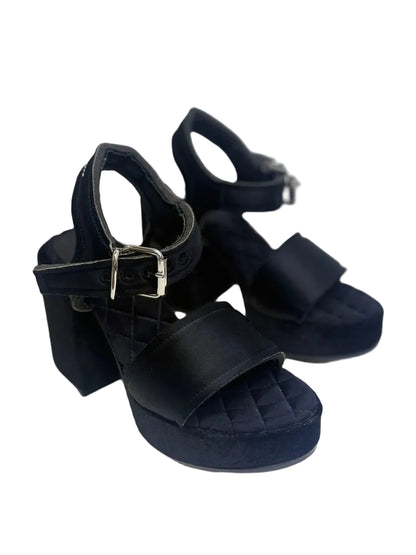 Black platform sandals on a white background