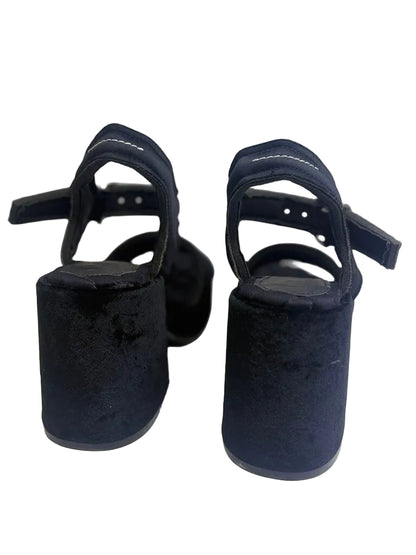 Pair of black high-heeled shoes on a white background