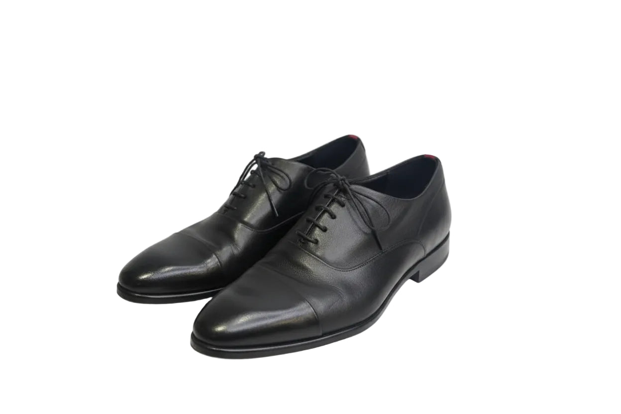 Pair of black dress shoes on a white background