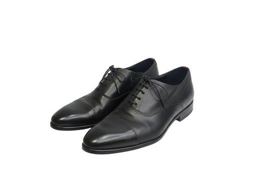 Pair of black dress shoes on a white background