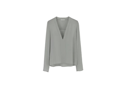 Light gray blouse on a hanger against a white background