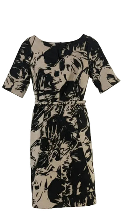 Beige and black patterned dress on a white background